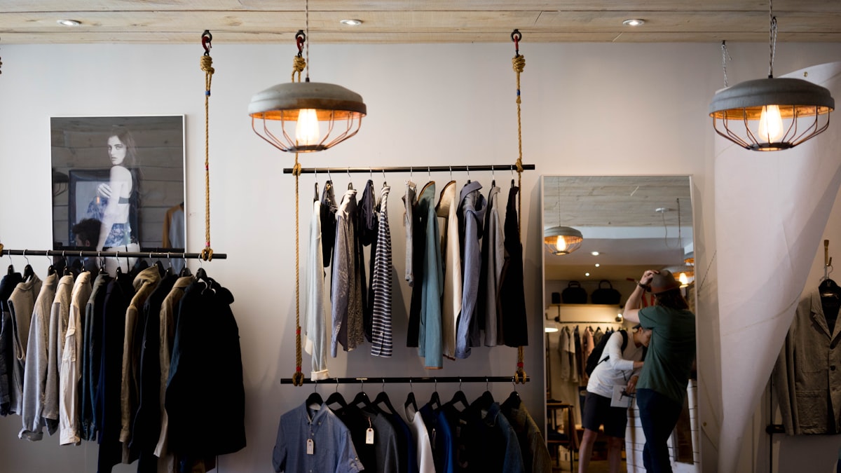 Inside a clothing store lit by warm lamps in the evening