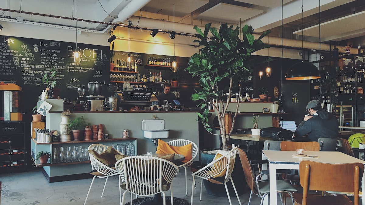 An owner behind a cafe counter during a working day
