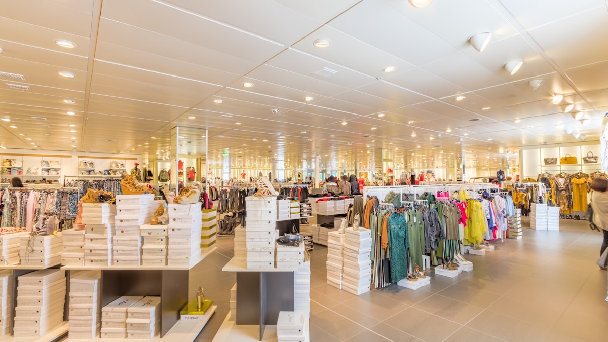 Large store floor with customers among displays and clothing racks
