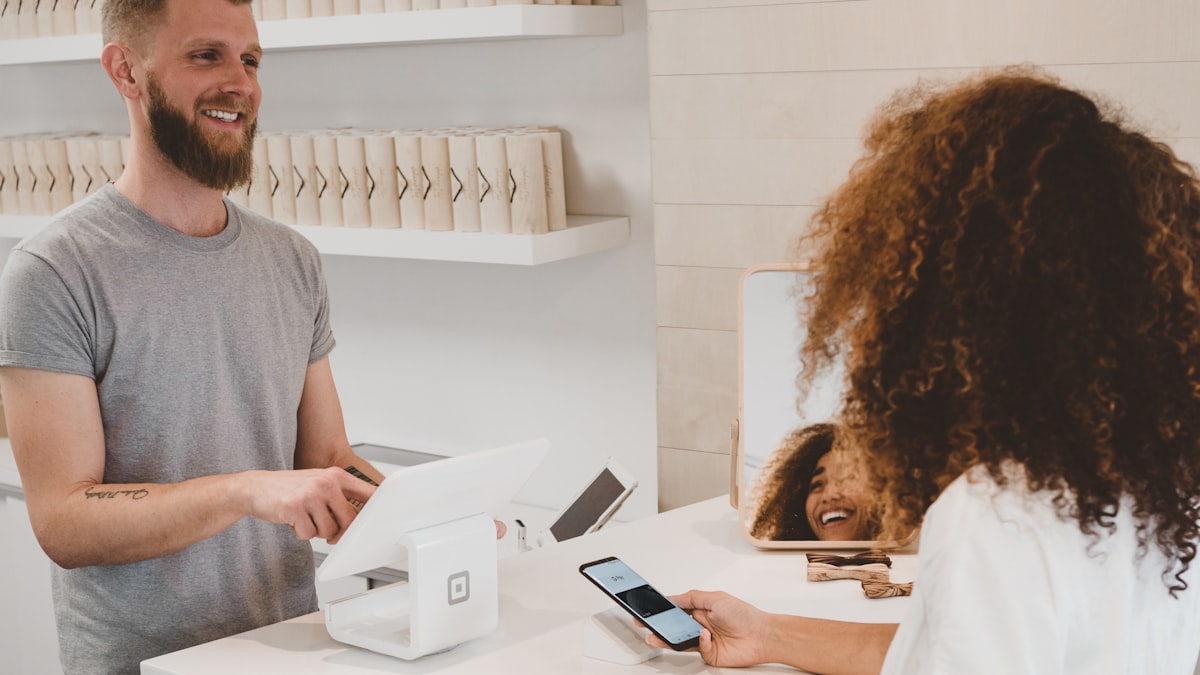 Regular customer chatting with a shop assistant at the counter